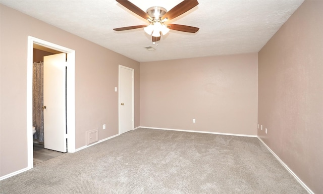 carpeted empty room featuring a textured ceiling and ceiling fan