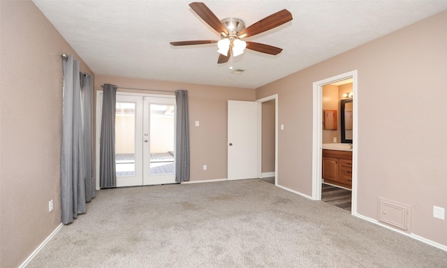 empty room with light colored carpet, french doors, and ceiling fan