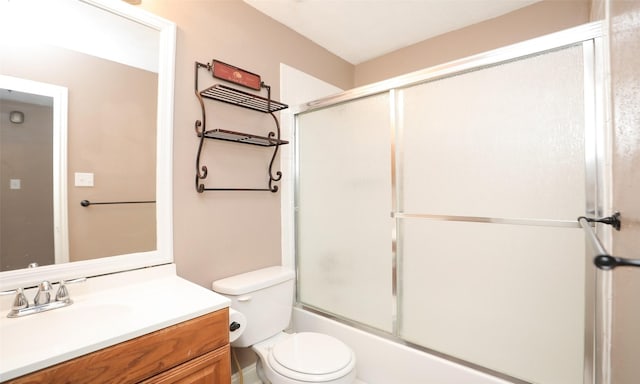 full bathroom with vanity, enclosed tub / shower combo, and toilet