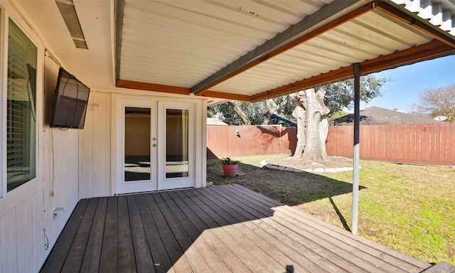 wooden terrace featuring french doors and a yard