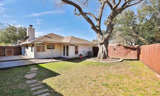 back of house with a wooden deck, a yard, and central AC