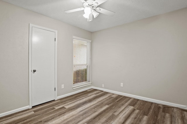 empty room featuring hardwood / wood-style flooring, ceiling fan, and a textured ceiling