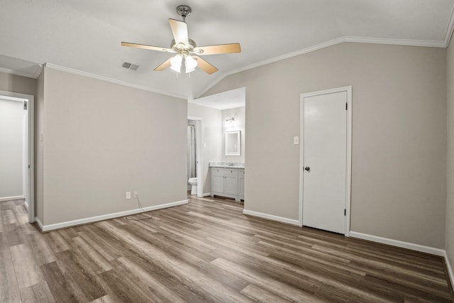 unfurnished bedroom featuring wood-type flooring, lofted ceiling, and crown molding