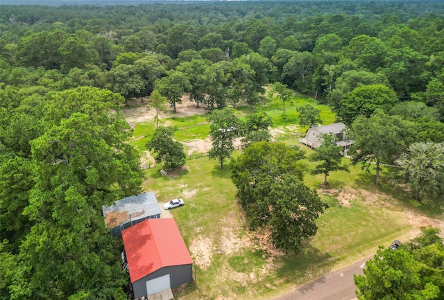 birds eye view of property featuring a view of trees