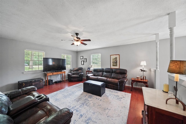 living area featuring ceiling fan, baseboards, a textured ceiling, and wood finished floors