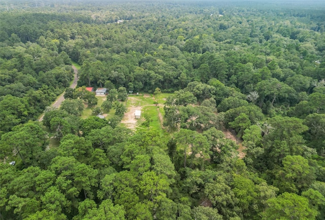 birds eye view of property featuring a forest view