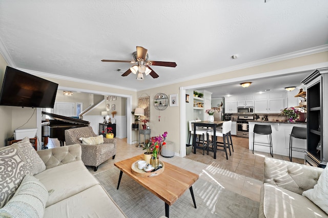 tiled living room with ceiling fan, ornamental molding, and a textured ceiling