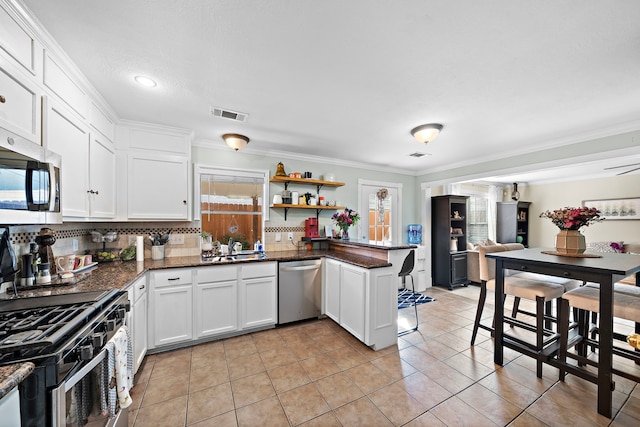 kitchen with stainless steel appliances, white cabinetry, ornamental molding, and kitchen peninsula