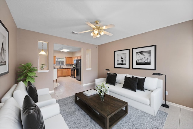 living room with ceiling fan and light tile patterned floors