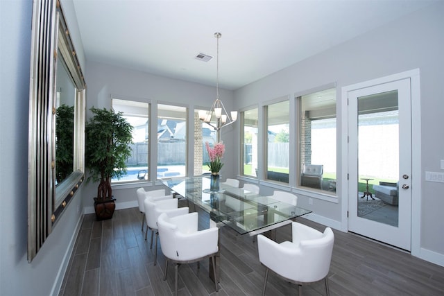 sunroom / solarium featuring a notable chandelier and a wealth of natural light