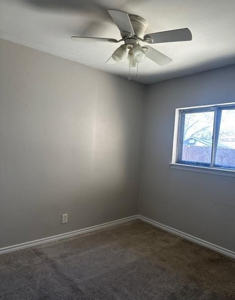 unfurnished room with dark colored carpet and ceiling fan