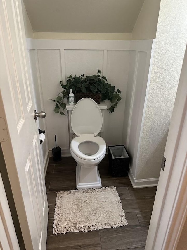 bathroom with hardwood / wood-style floors and toilet