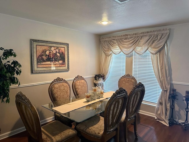 dining space with dark hardwood / wood-style floors