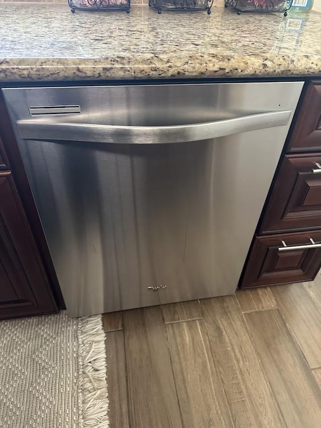 room details featuring dark brown cabinetry, dishwasher, and light wood-type flooring