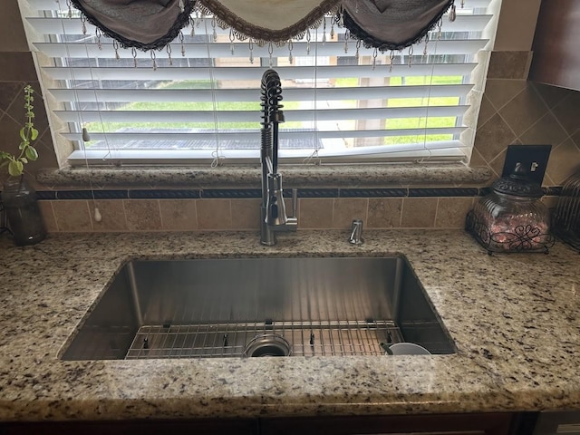 room details featuring sink and decorative backsplash