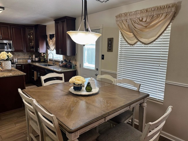 dining room with sink and dark hardwood / wood-style floors