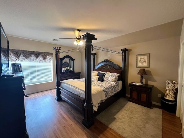 bedroom with hardwood / wood-style floors and ceiling fan