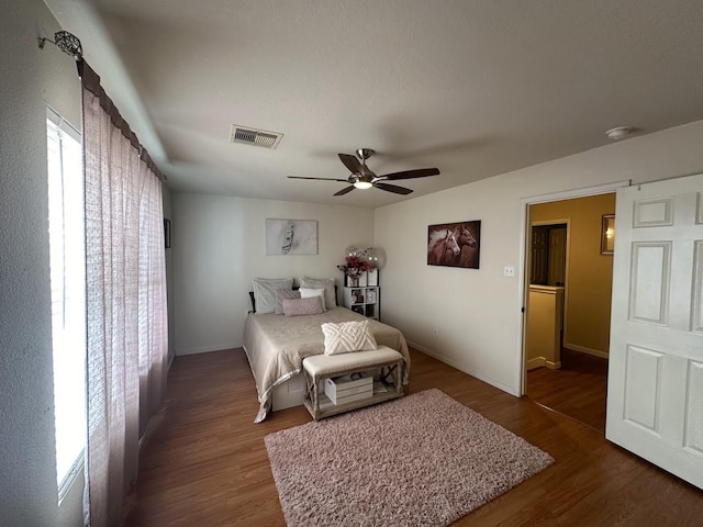 bedroom with ceiling fan and dark hardwood / wood-style flooring