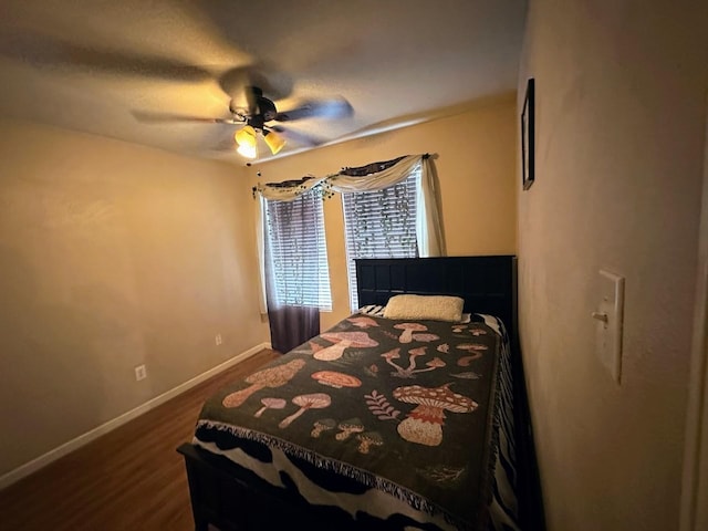 bedroom featuring dark wood-type flooring and ceiling fan