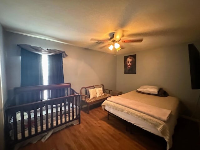 bedroom featuring ceiling fan and hardwood / wood-style floors