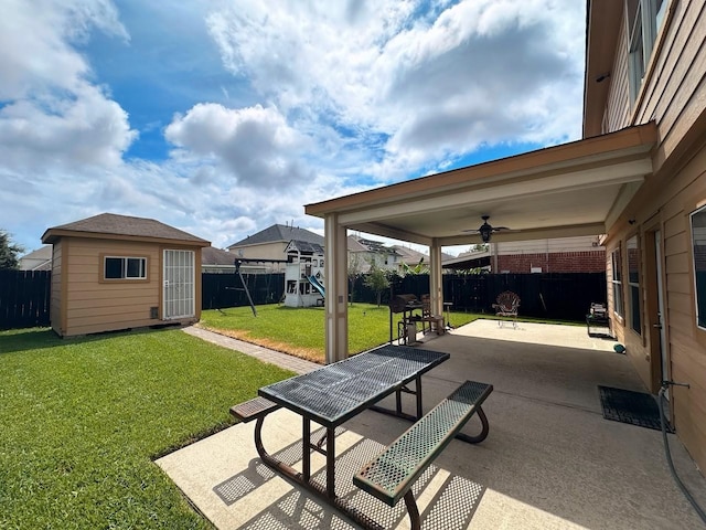 view of community with a yard, a patio area, and a shed