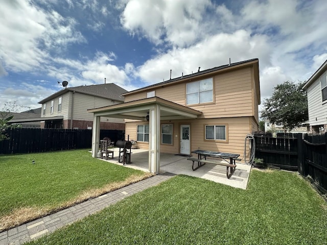 back of house featuring a lawn, a patio, and ceiling fan