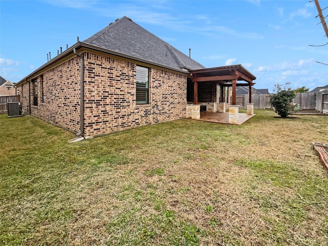 back of house featuring a yard, a patio area, and central AC