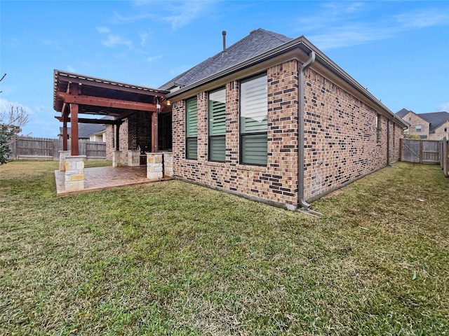 view of side of property with a yard and a patio