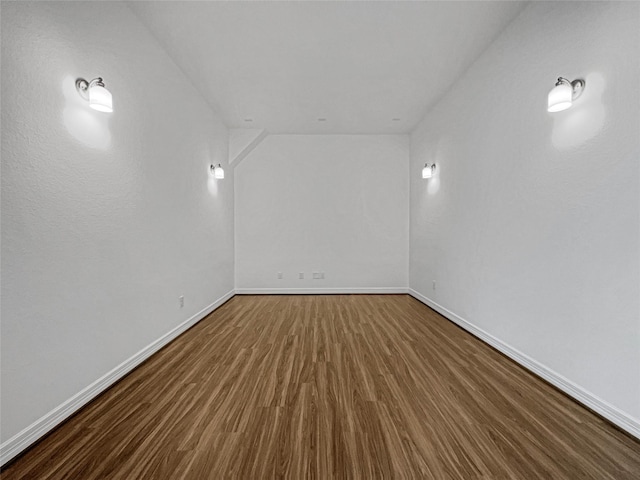 bonus room with dark hardwood / wood-style floors