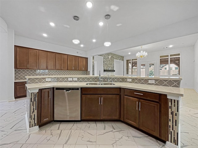 kitchen with a kitchen island with sink, dishwasher, sink, and hanging light fixtures