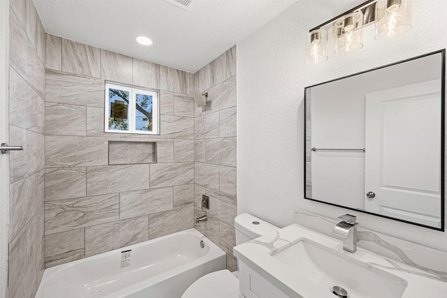 bathroom featuring a textured wall, toilet, bathing tub / shower combination, a textured ceiling, and vanity