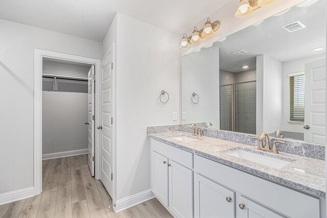 bathroom with vanity, hardwood / wood-style floors, and walk in shower