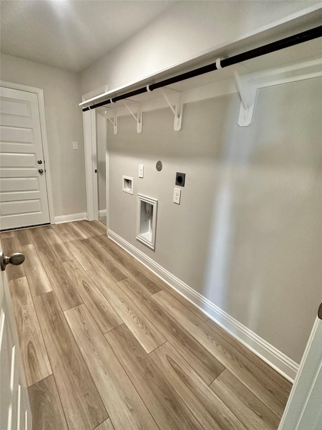 laundry room with gas dryer hookup, laundry area, baseboards, light wood finished floors, and electric dryer hookup