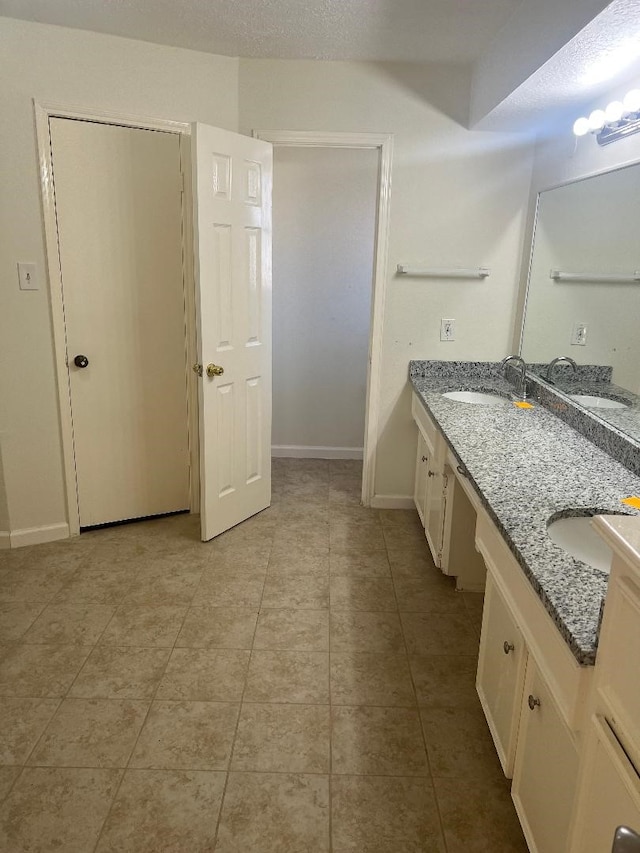 bathroom with vanity and tile patterned flooring