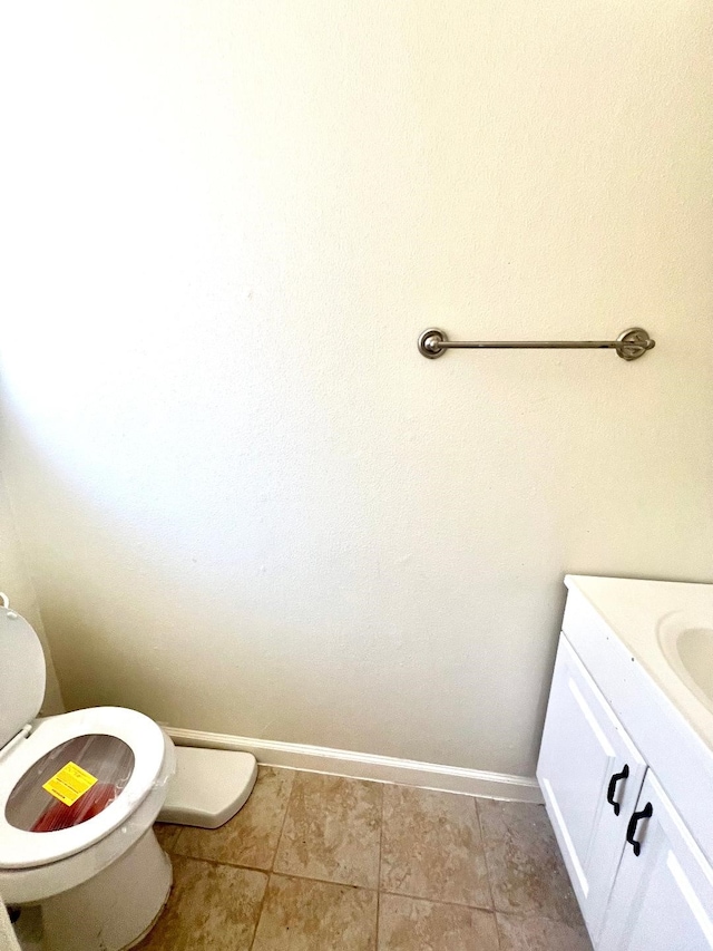 bathroom with vanity, tile patterned flooring, and toilet