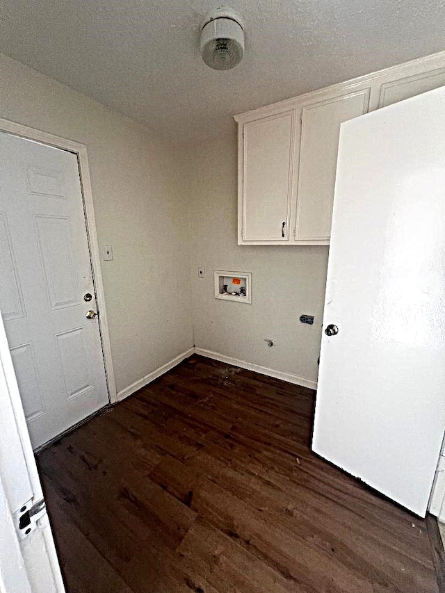 laundry area featuring hookup for a washing machine, dark wood-type flooring, and cabinets