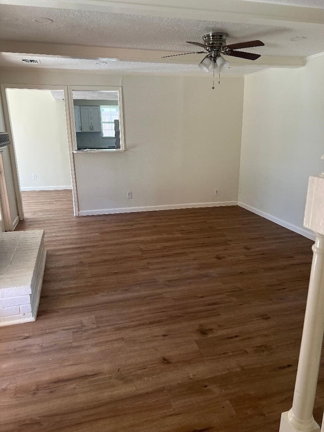 spare room with dark hardwood / wood-style floors, a textured ceiling, and ceiling fan