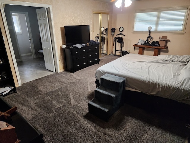 carpeted bedroom featuring connected bathroom and multiple windows