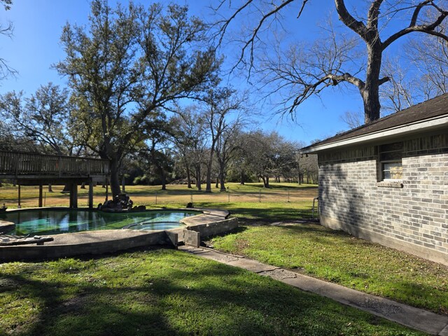 view of yard featuring a swimming pool side deck