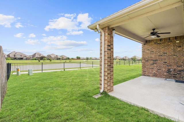 view of yard with ceiling fan and a patio area