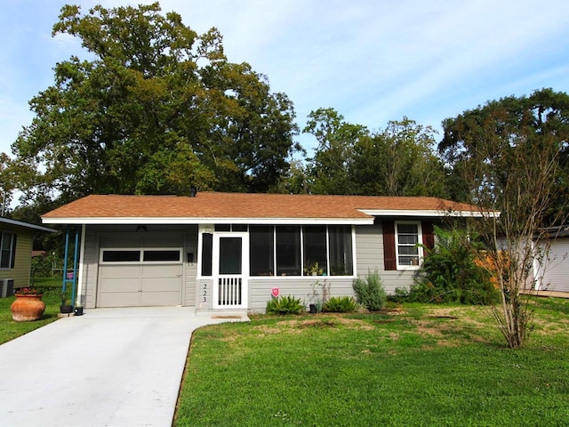 ranch-style house with a garage, a front lawn, and central air condition unit