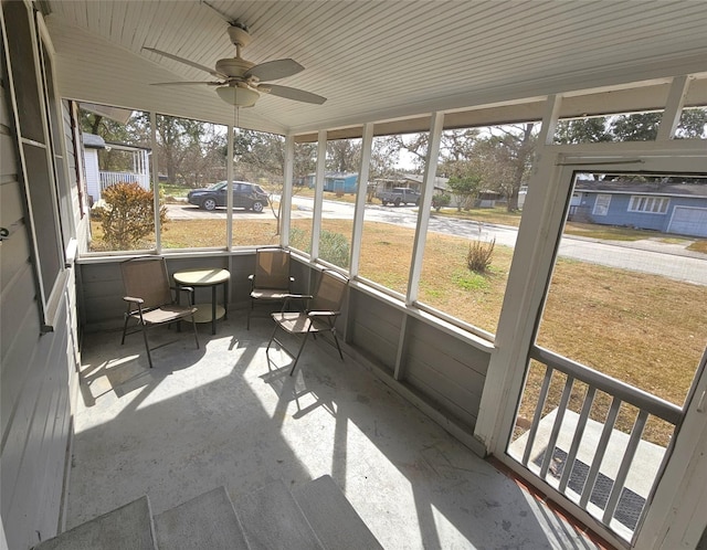 sunroom / solarium featuring ceiling fan