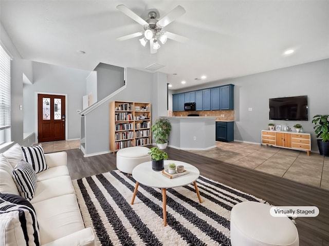 living room with ceiling fan and wood-type flooring