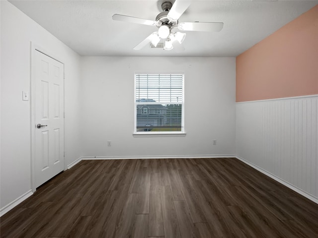 unfurnished room featuring ceiling fan and dark hardwood / wood-style flooring