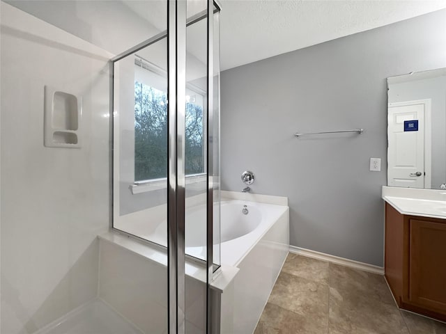 bathroom with vanity, separate shower and tub, and a textured ceiling