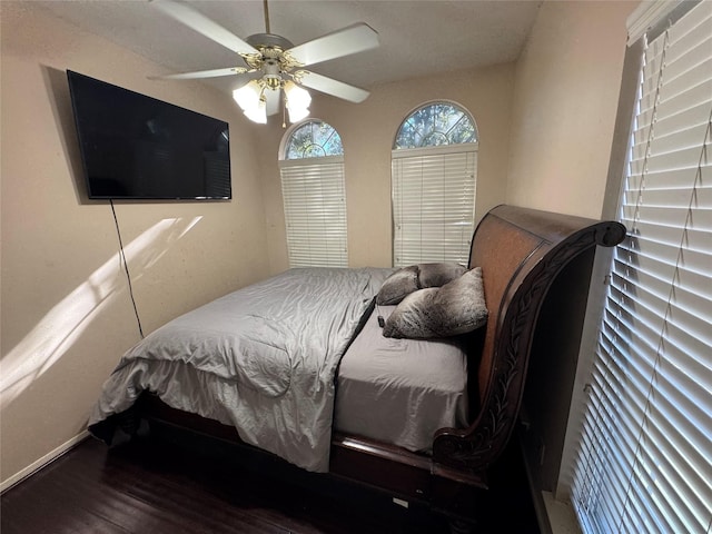 bedroom with ceiling fan and wood-type flooring