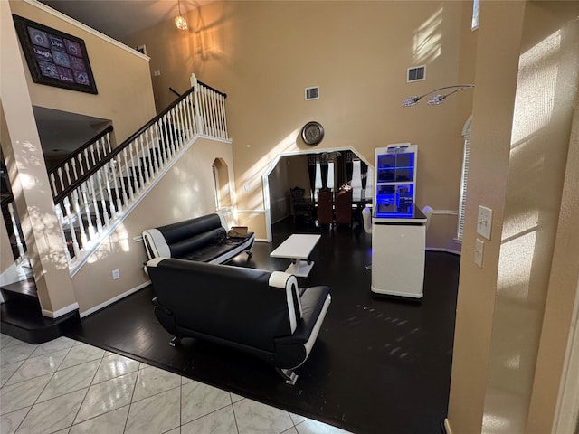 tiled living room featuring a high ceiling