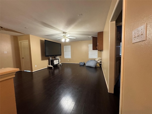 unfurnished living room with ceiling fan and hardwood / wood-style floors