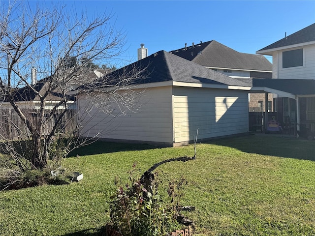 view of side of home with a yard