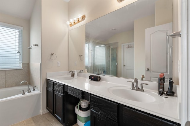 bathroom with tile patterned flooring, vanity, and separate shower and tub